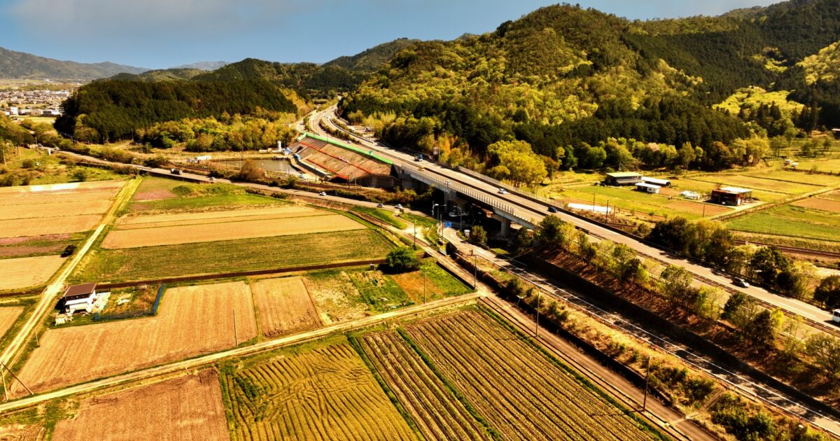 田園風景と高速道路が交差する空撮写真